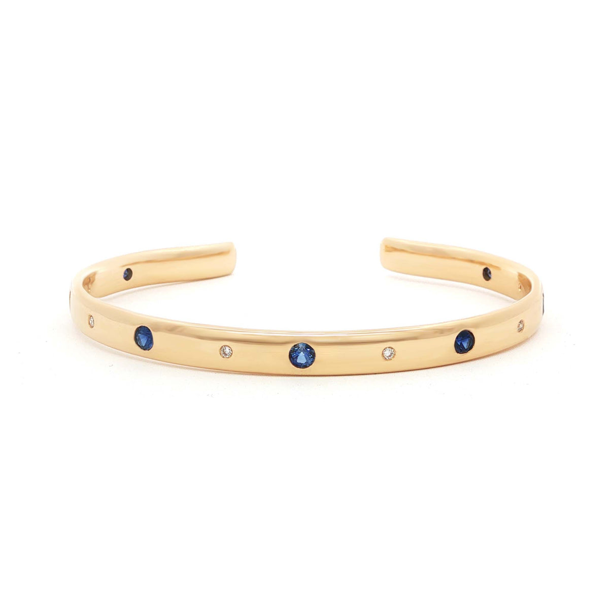 The Ratio Cornerstone Cuff, a 14k gold open cuff with alternating gemstones and diamonds